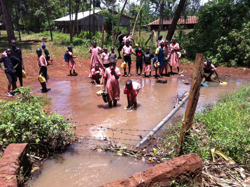 Photo of Children collecting water